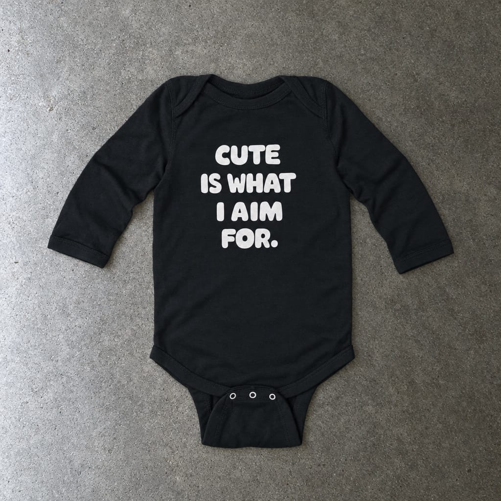 Cute Is What I Aim For long sleeve onesie in black, laid flat