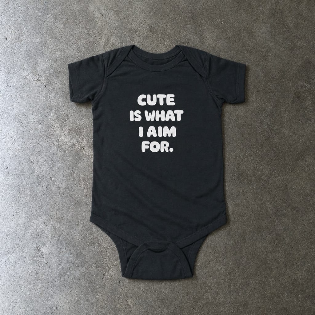 Cute Is What I Aim For onesie in black, laid flat