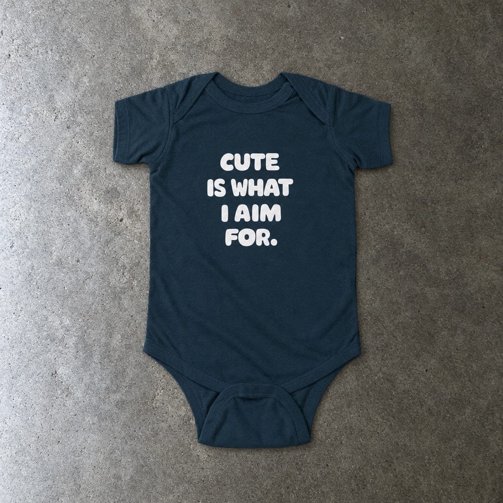 Cute Is What I Aim For onesie in navy, laid flat