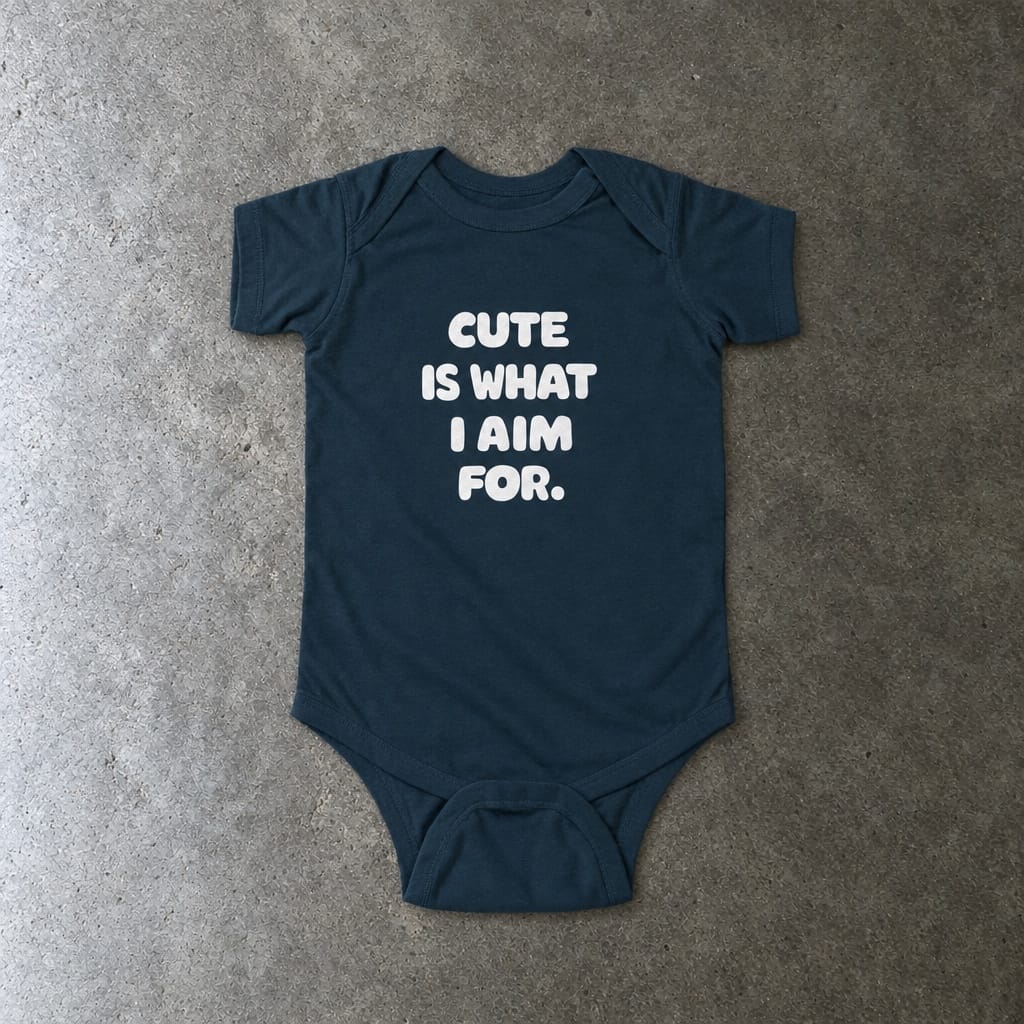 Cute Is What I Aim For onesie in navy, laid flat