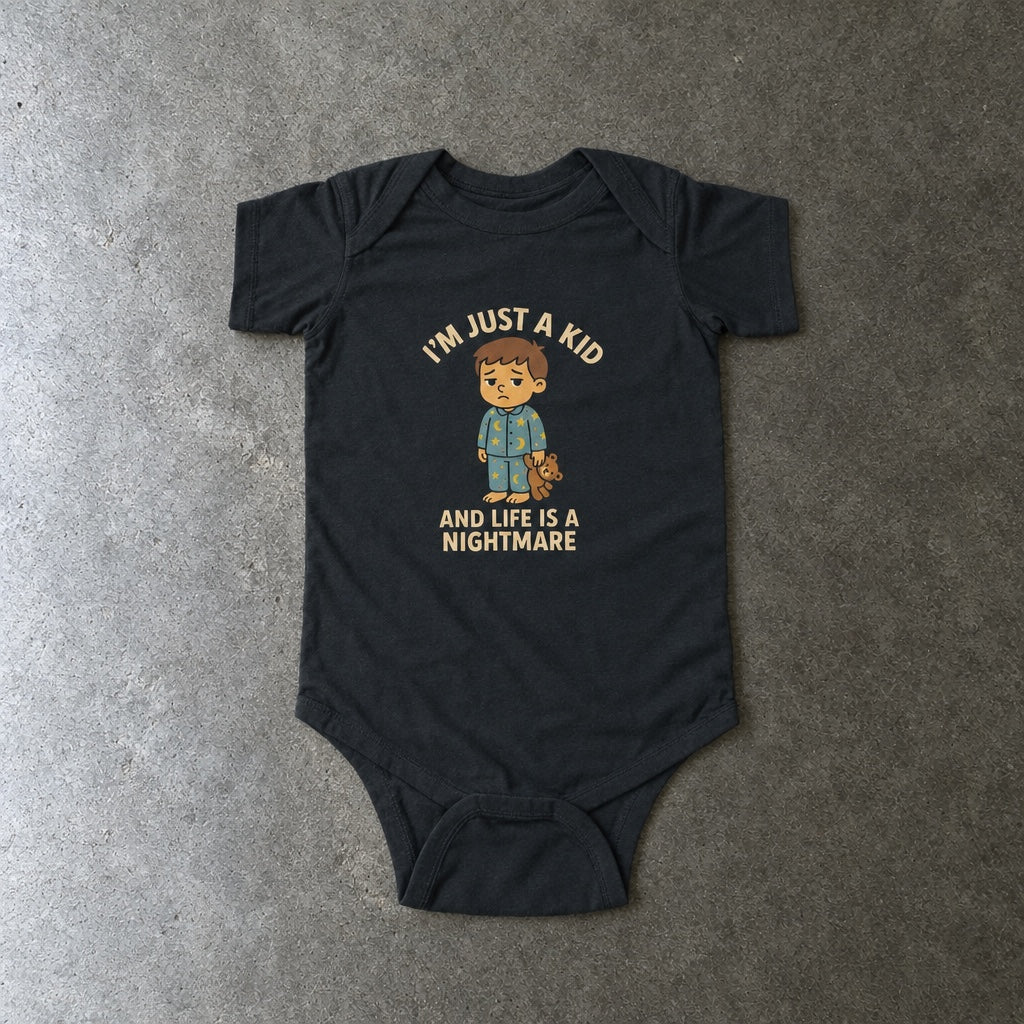 I'm Just A Kid onesie in black, laid flat