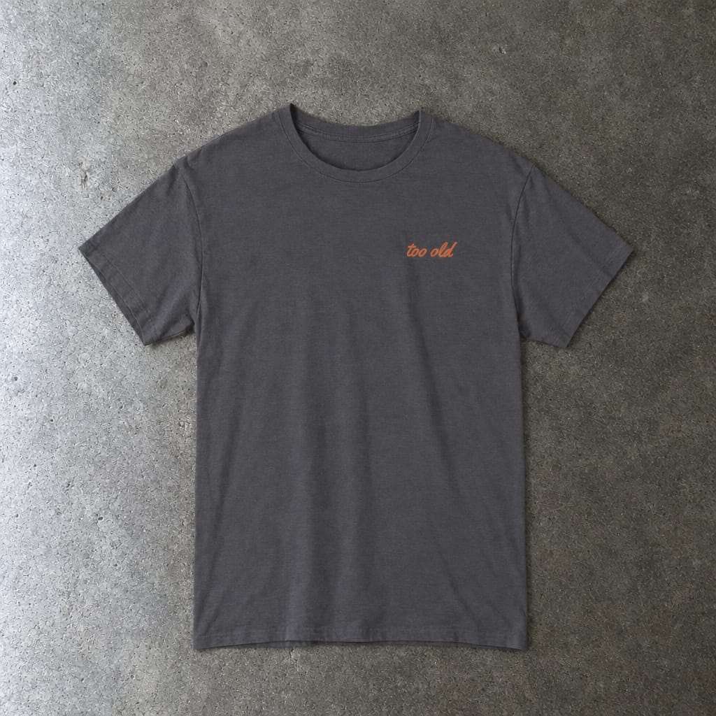 I'm Too Old For This Pit Danny Tee in charcoal, laid flat
