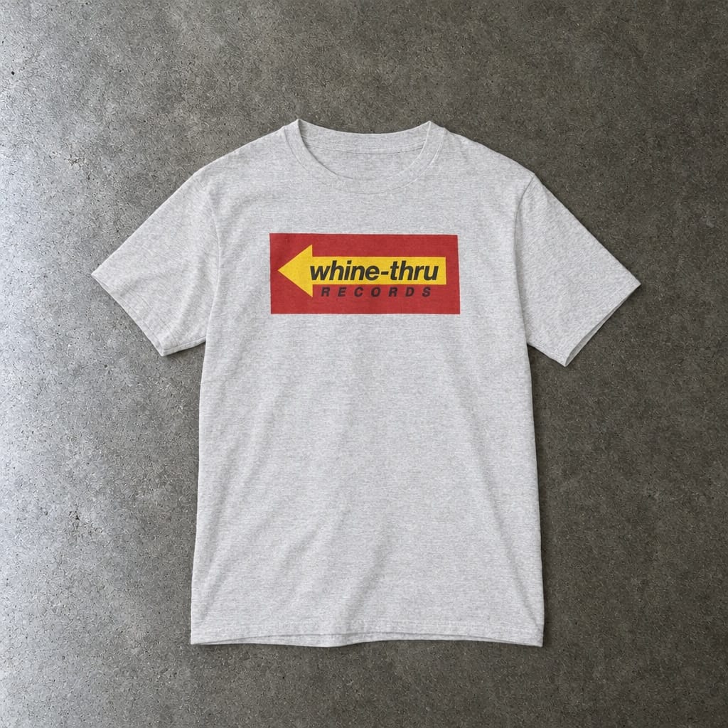Whine-Thru Records youth tee in ash, laid flat