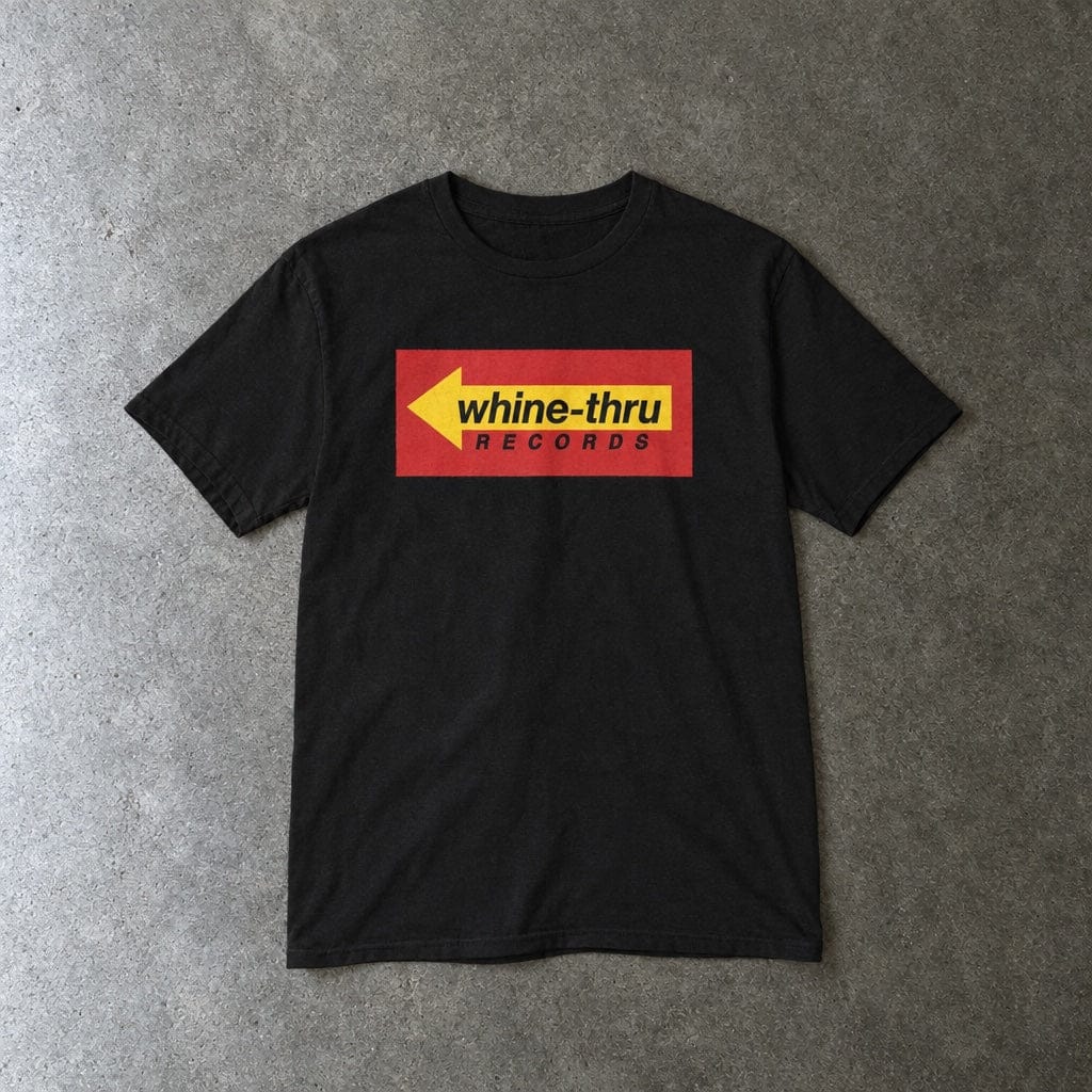 Whine-Thru Records youth tee in black, laid flat