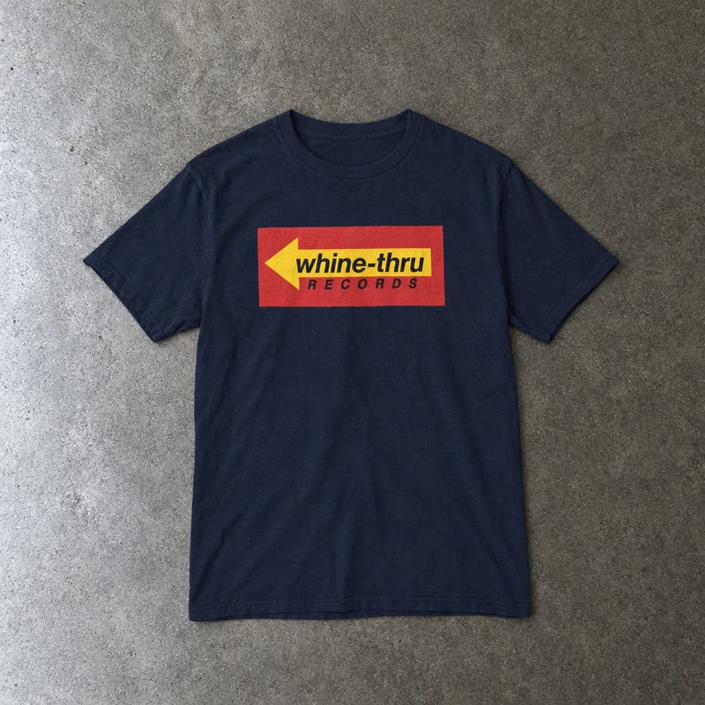 Whine-Thru Records youth tee in navy, laid flat