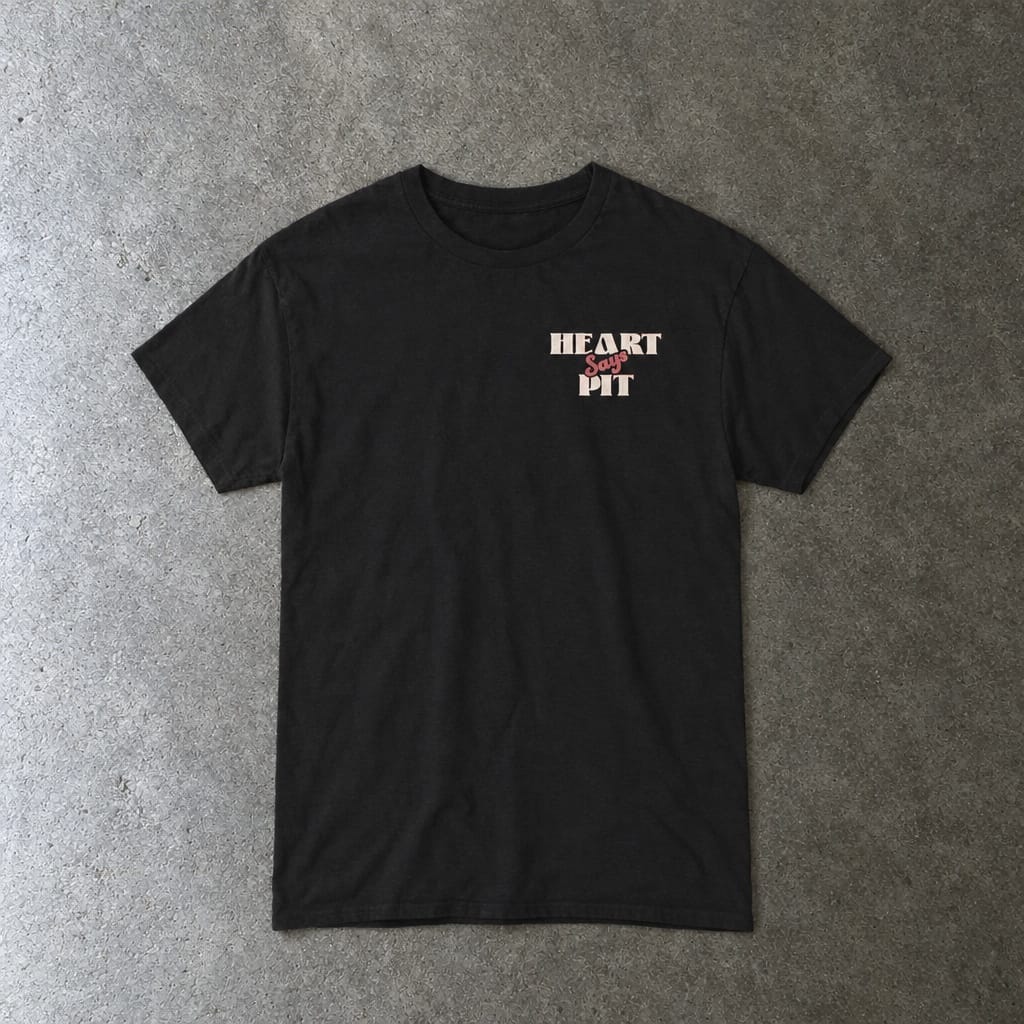 Heart Says Pit, Knees Say Sit Tee in black, laid flat