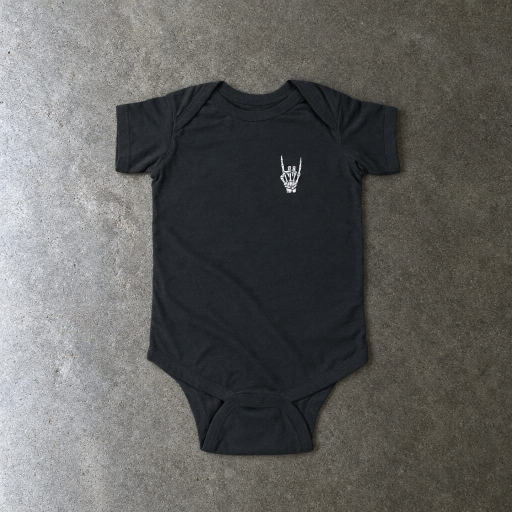 Rock On onesie in black, laid flat
