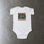 Screaming Infant Melodies onesie in white, laid flat