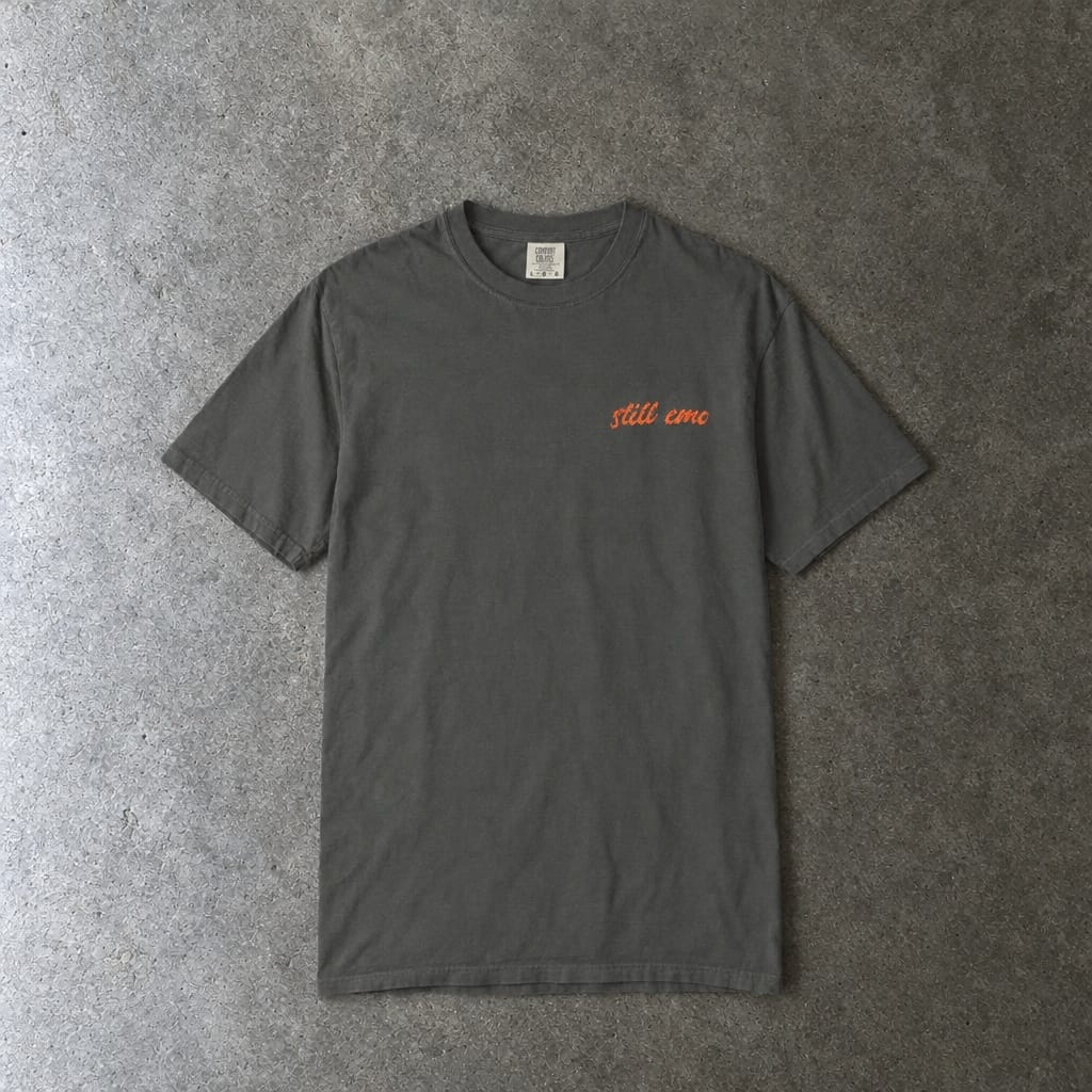 Still Emo Embroidered Tee in pepper, laid flat